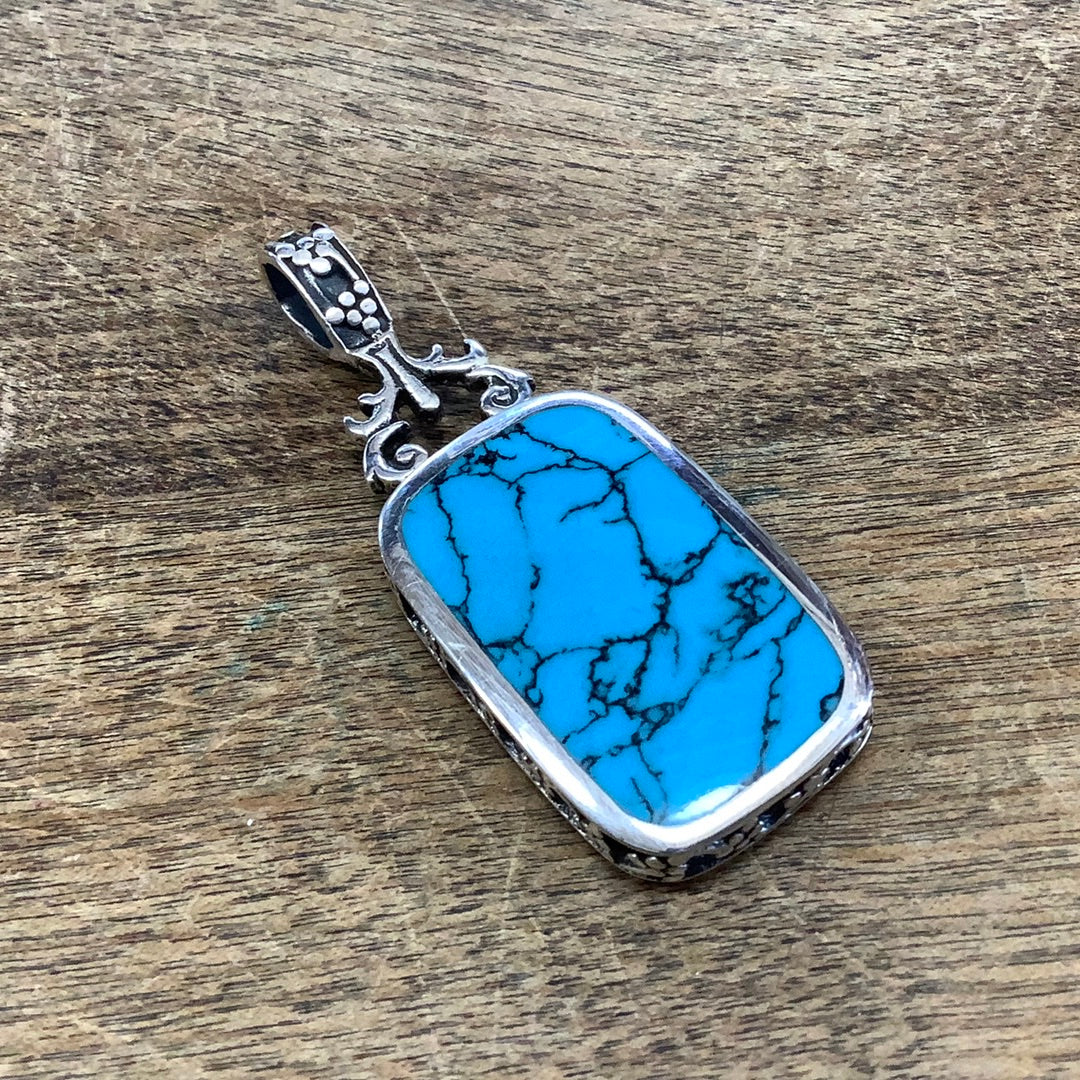 Sterling silver reversible black onyx and dyed howlite pendant