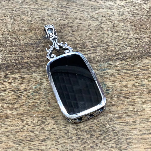 Sterling silver reversible black onyx and dyed howlite pendant
